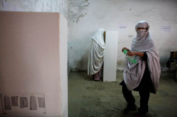 Peshawar, Pakistan: A woman casts her ballot