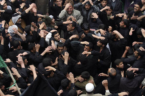 Shia pilgrims beat their chests during the Arbaeen religious holiday