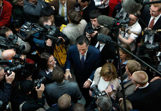 Mitt Romney is surrounded by members of the press