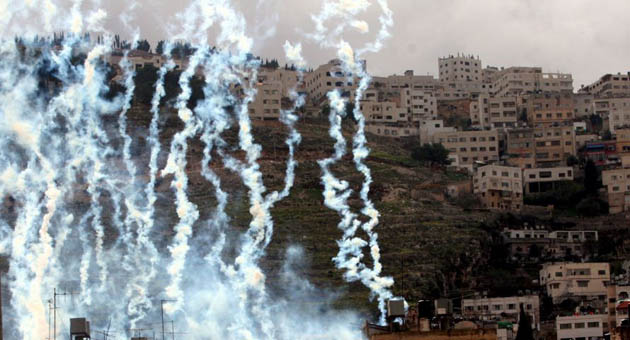 Israeli soldiers fire rounds of tear gas during clashes