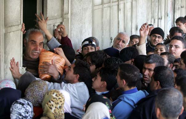 Palestinian trying to buy bread at a bakery in Gaza