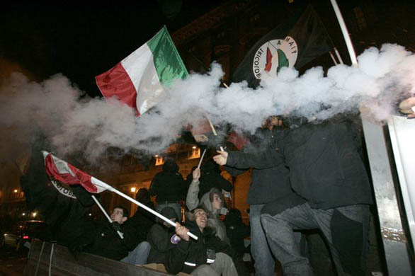 People holding Italian Fiamma Tricolore right-wing party flags, celebrate after a confidence vote in the Senate