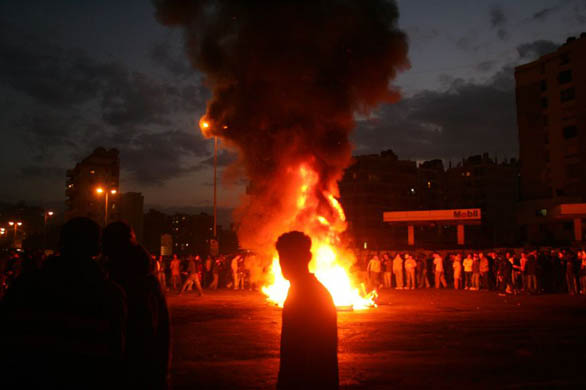 Protesters burn tyers during a demonstration over power cuts