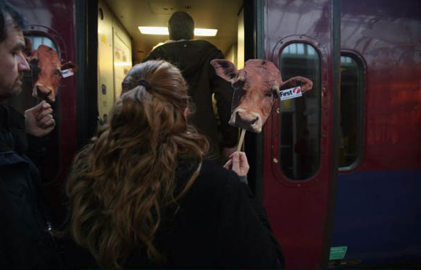 A commuter protester from Bristol-based passenger group, 'More Train Less Strain', holds a placard urging passengers to take a fare strike