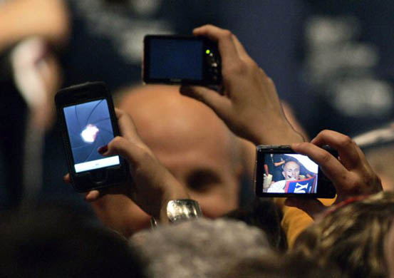 Supporters photograph Rudy Giuliani as he signs autographs