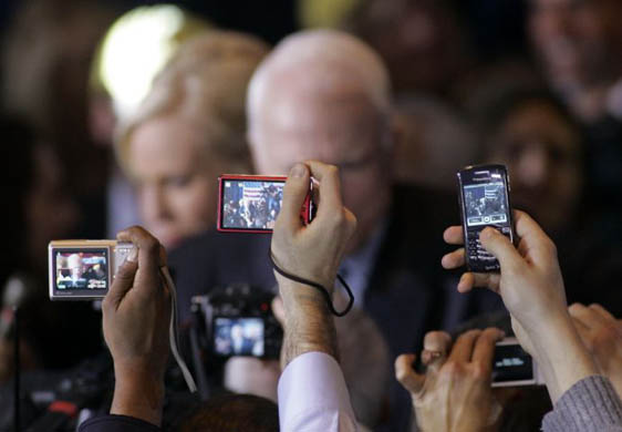 Supporters photograph John McCain at the Florida primary celebration