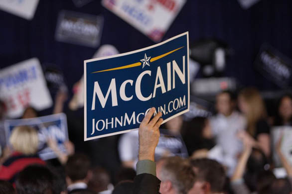 A supporter holds a campaign sign for John McCain