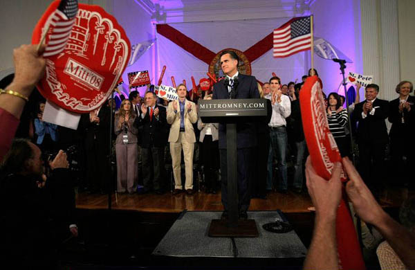 Mitt Romney pauses as he speaks during a post primary campaign rally