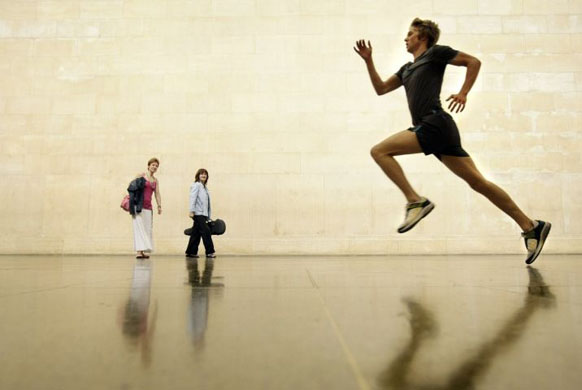 London, UK: A runner speeds through Tate Britain's neo-classical sculpture galleries as part of a live art installation entitled 'Work No. 850' by Martin Creed
