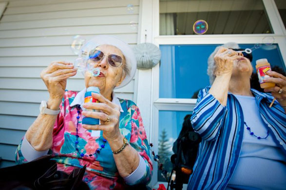 Coeur d'Alene, US: Thelma O'Dell, left, and Lois Jacobson blow bubbles during a wheelchair parade at Legends Park Assisted Living