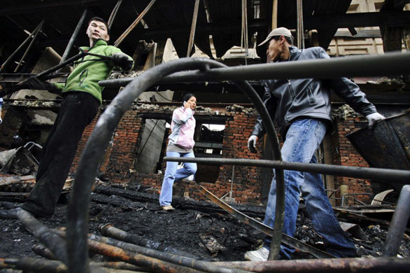 Ulan Bator, Mongolia: Workers scavenge through the remains of the Palace of Culture