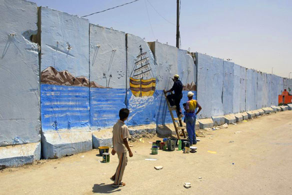 painting the security wall in sadr city, baghdad, iraq