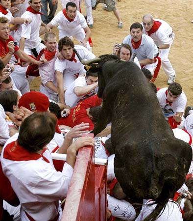 Bull jumps onto revelers in the bullring