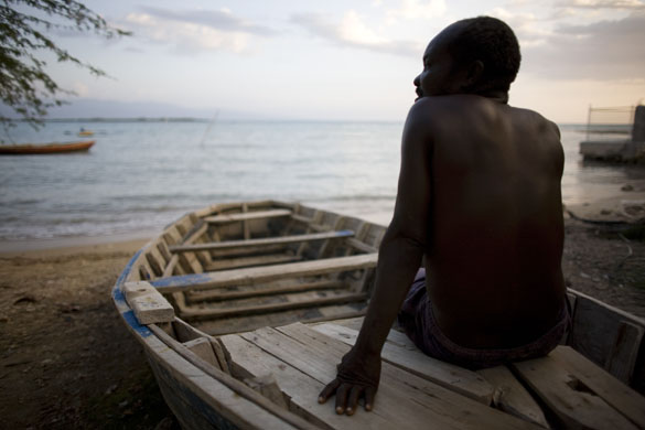 Port-au-Prince, Haiti: A fisherman takes a rest on his boat at Ibo beach. Photograph: Alexandre Meneghini/AP