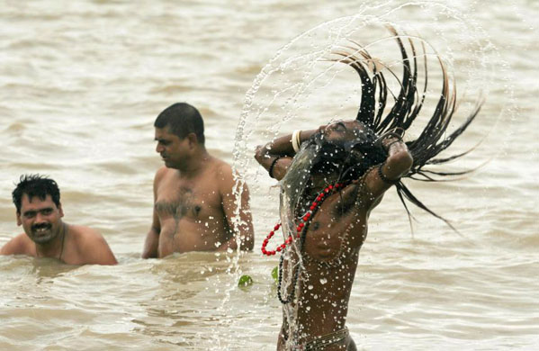 a sadhu bathes in the ganges 