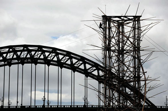 Newcastle, UK: A man finishes one of the 25 metre bamboo towers which will span the river Tyne using 20 tons of bamboo