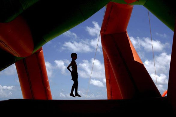 Punta Cana beach, Dominican Republic: A boy jumps on an inflatable attraction
