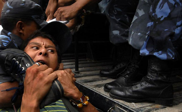 Kathmandu, Nepal: Police detain a Tibetan activist during an anti-Chinese demonstration