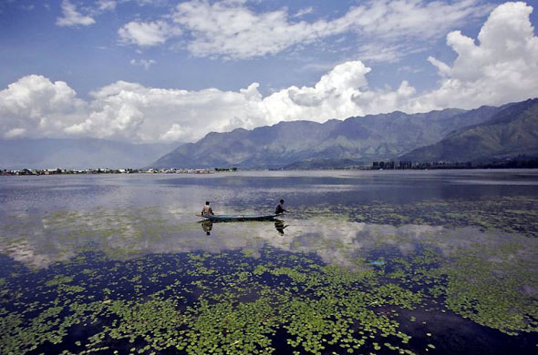 Srinagar, India: People fish on Dal lake