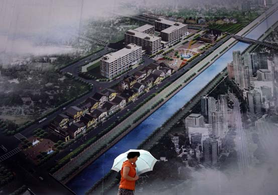 woman walks past billboard