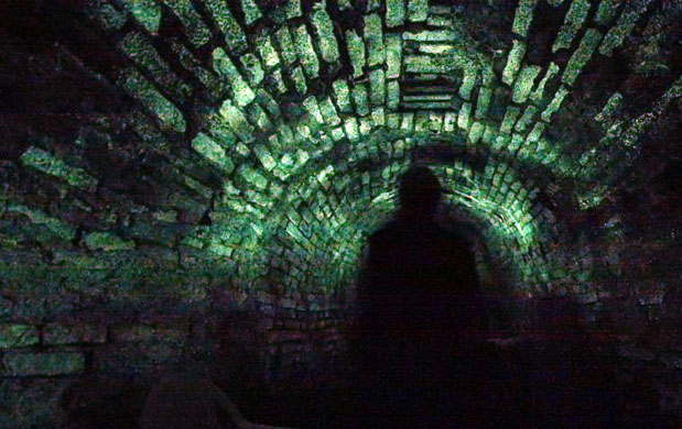 Prague, Czech Republic: A visitor's silhouette at newly discovered tunnel beneath the city