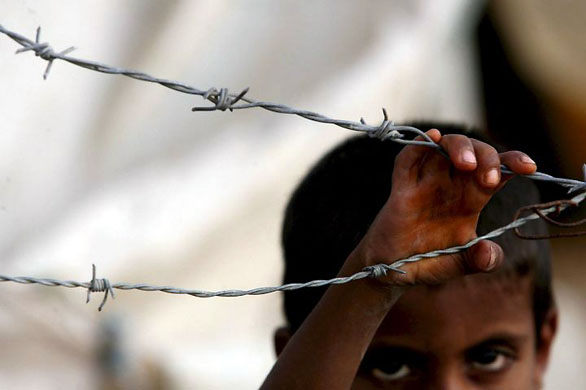 Gaza Strip: A Palestinian boy stands outside a makeshift tent