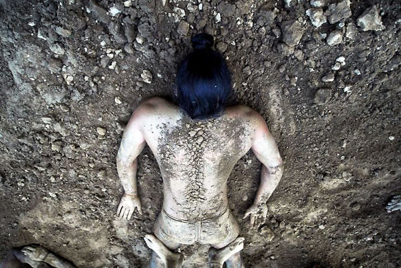 Amritsar city, India: A wrestler gets a massage as part of his daily exercise routine