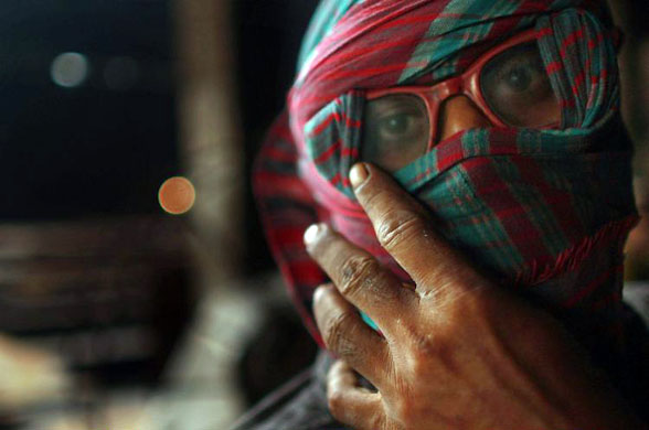 Dhaka, Bangladesh: An employee at a steel factory pauses while making steel rods out of cargo ship scrap metal