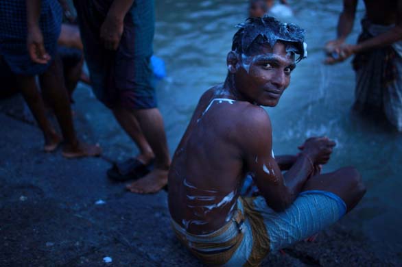boy washes in the Buriganga River