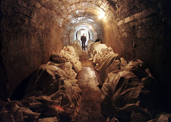 1997, Tuzla: Stacks of unidentified corpses line the walls of an underground shelter at a morgue