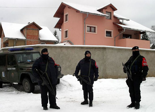 January 2004, Pale, Bosnia: Peacekeepers stand in front of the house of Radovan Karadzic during a search