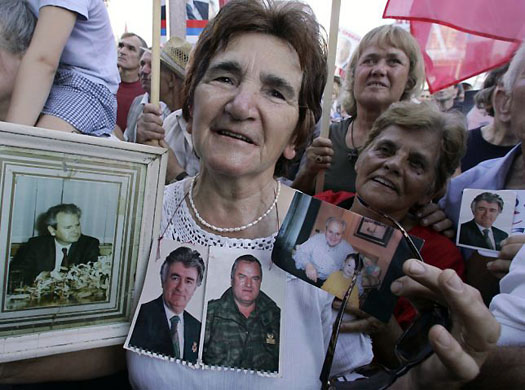 June 2005, Belgrade, Serbia: Hardline supporters show photos of Slobodan Milosevic, Radovan Karadzic and Ratko Mladic