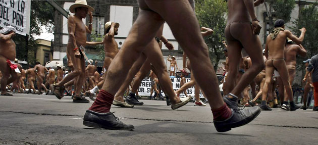 Mexico City, Mexico: Men from the '400 Pueblos' group, wearing only shoes, march during a protest