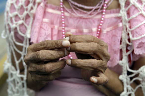 Lima, Peru: A patient at Larco Herrera's psychiatric hospital waits to take part in a parade