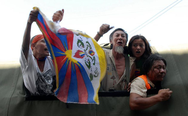 Kathmandu, Nepal: Tibetan activists shouts slogans from the back of a police vehicle following their arrest during an anti-Chinese demonstration