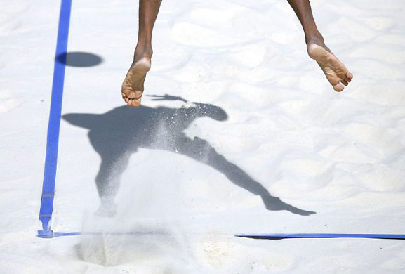Gstaad, Switzerland: Harley Marques from Brazil serves a ball during the semi final game against the Brazil  at the Beach Volleyball World Tour