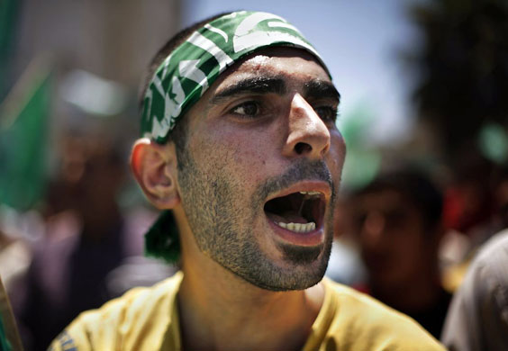 Hebron, West Bank: A mourner chants slogans during the funeral of Hamas militant Shehab Natche