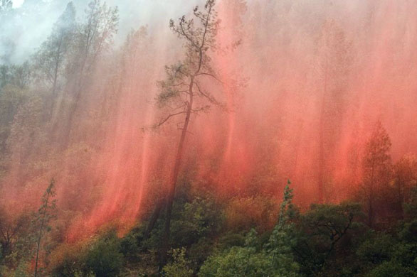 Yosemite Valley National Park, US: Retardant from a helicopter showers down as the Telegraph fire burns out of control