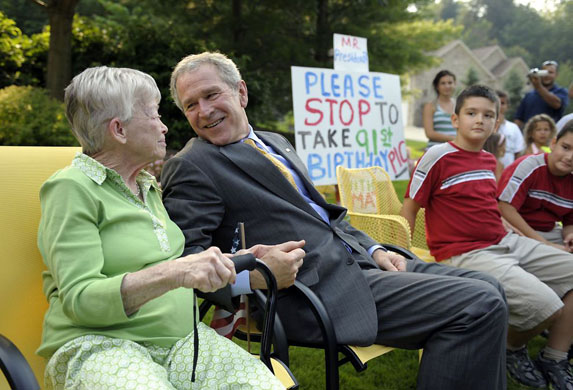 Gates Mills, US: After attending a fundraiser George Bush stops to take a picture with Ruth Harris, who was celebrating her 91st birthday
