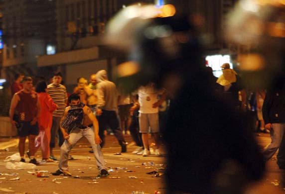 Protesters and riot police clash