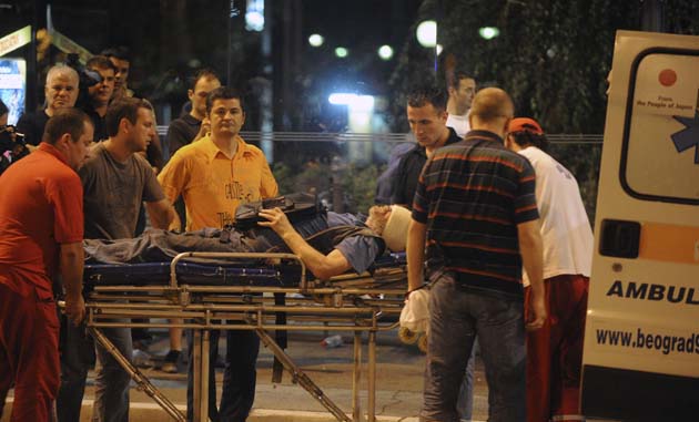 A man injured in clashes with police in downtown Belgrade is taken to an ambulance