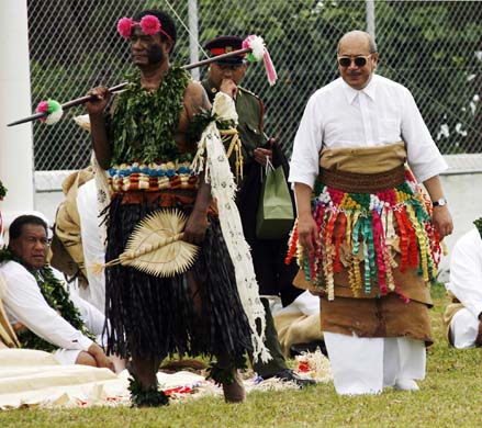 Tonga's King George Tupou V is lead from an installation ceremony 