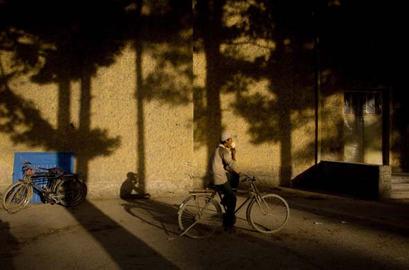 A cyclist enjoying an ice cream cone in Kabul 