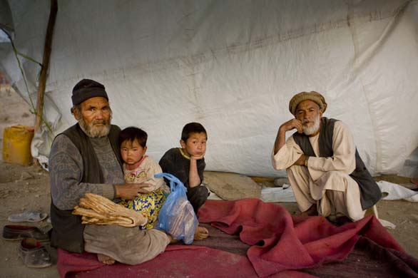 A family under a tent selling bread near a shiite cemetery in Kabul.