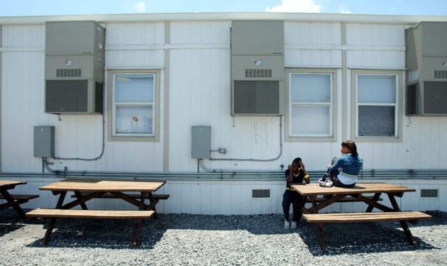 Students sit outside a classroom at Edward Livingston High School in New Orleans