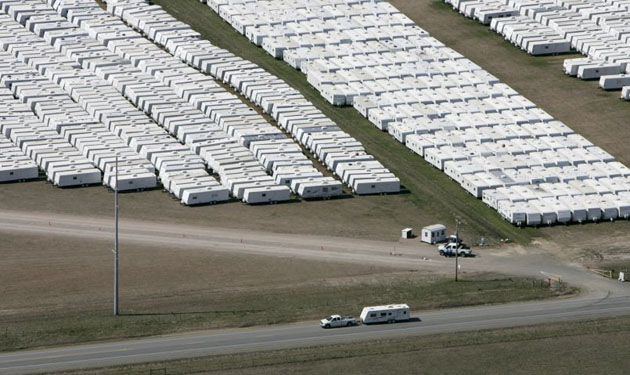 A pickup truck tows one of about 20,000 mobile homes and travel trailers owned by the FEMA from Hope Municipal Airport near Hope