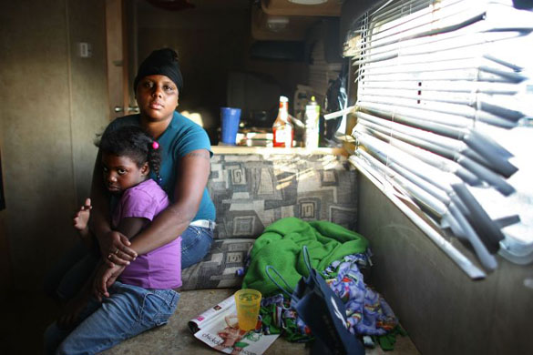 Nakeva Narcisse and daughter Asanta Mackey, 5, sit in their trailer in the FEMA Diamond trailer park in Louisiana 