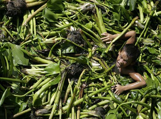 Boy plays in lake in Manila