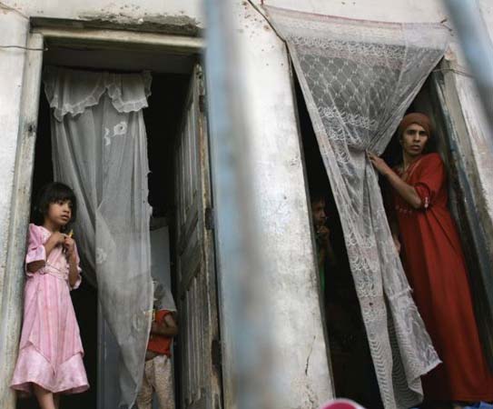 Iraqi civilans watch a soldier