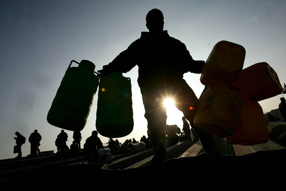 Palestinians transport goods they bought in Egypt back into the Gaza Strip, after they crossed the Rafah border into Egypt